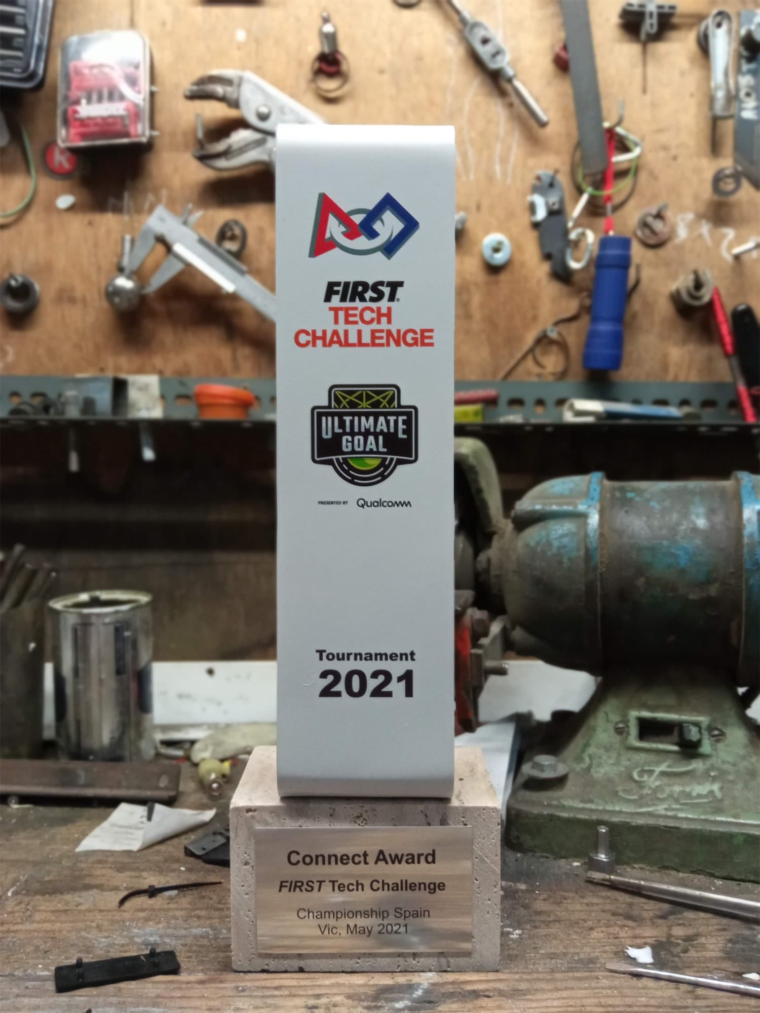 A FIRST Tech Challenge trophy on a workbench in the workshop